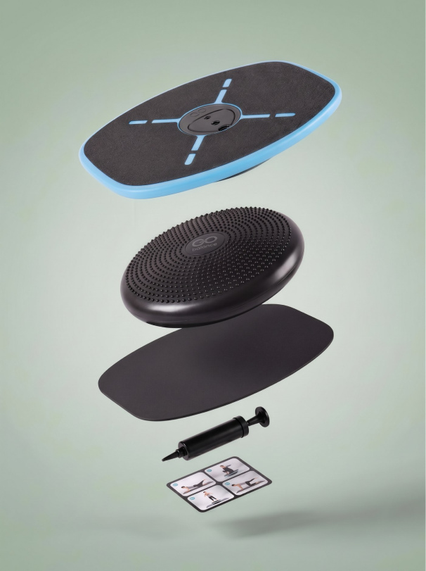 GoBalance Sport kit floating as a stack: board, balance cushion, yoga layer, pump and quick-start guide